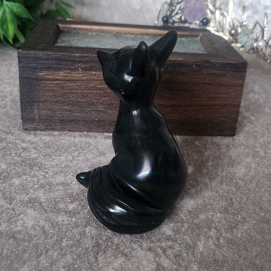 Obsidian fox crystal sculpture styled with rustic decor and soft neutral tones