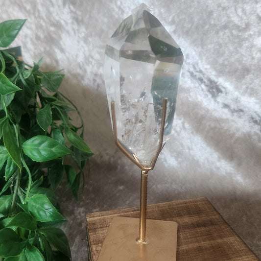 Polished Brazilian clear quartz point showcasing natural internal formations