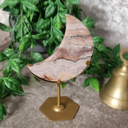 Polished crazy lace agate moon displaying swirling cream and brown tones