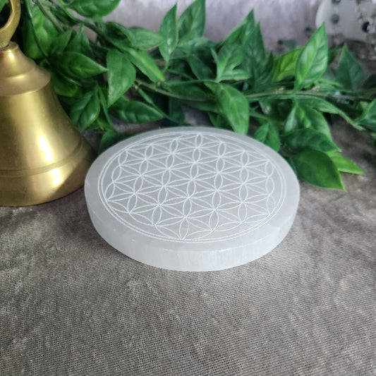 Round satin spar selenite plate with engraved Flower of Life pattern