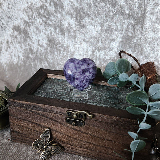 Purple lepidolite heart crystal displayed on wooden keepsake box with eucalyptus styling and vintage décor