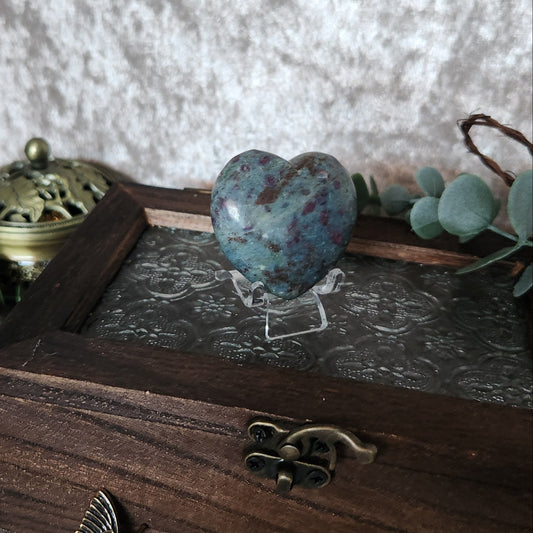 Ruby in kyanite heart crystal displayed on wooden keepsake box with soft eucalyptus and vintage décor