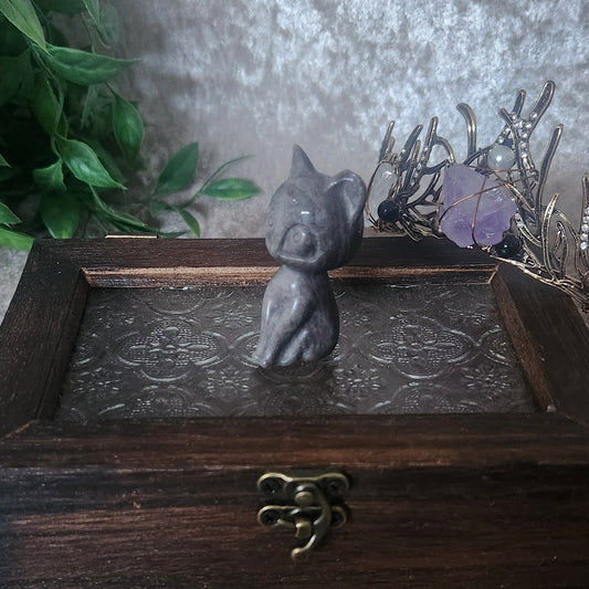 silver obsidian cat carving with beautiful silver sheen flash in vintage witchy decor setting