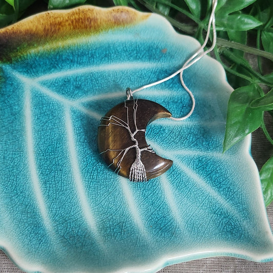 Polished tiger eye crescent moon pendant with chain included