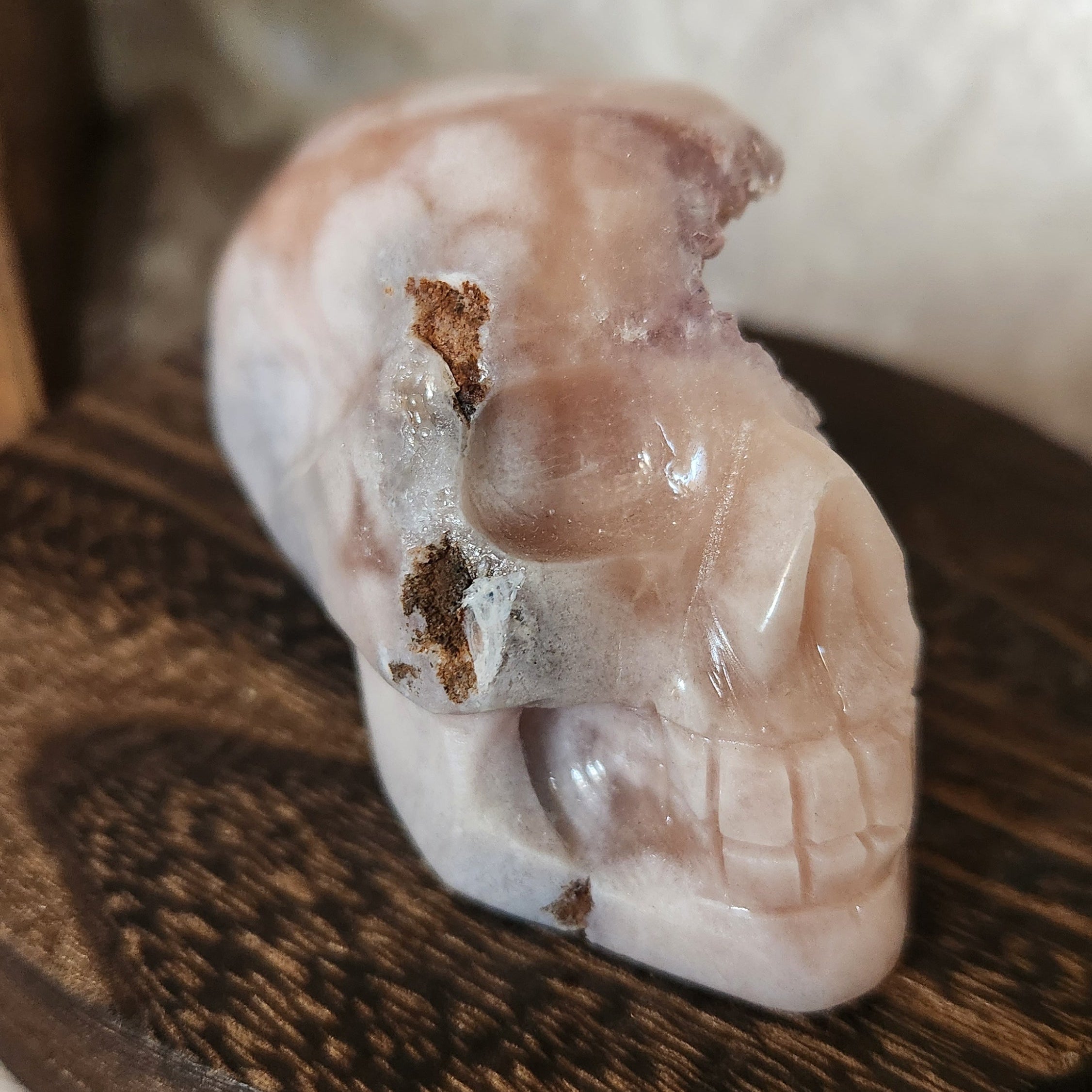 Hand-carved pink amethyst skull showing natural crystal sparkle