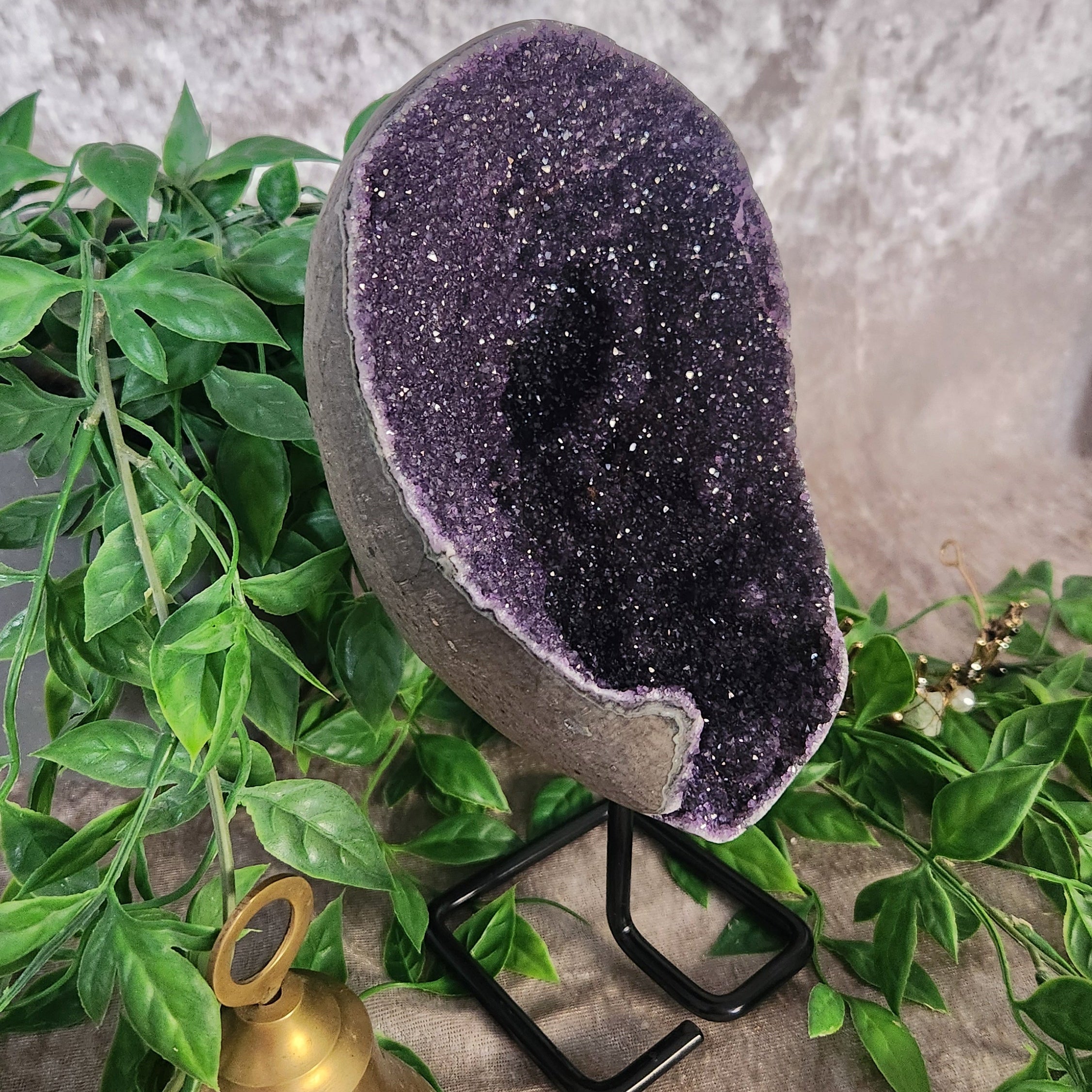 Amethyst Galaxy Geode on Stand with velvet background and greenery