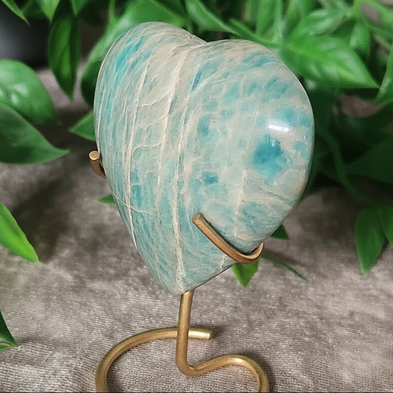 Polished amazonite heart featuring natural white veining on stand