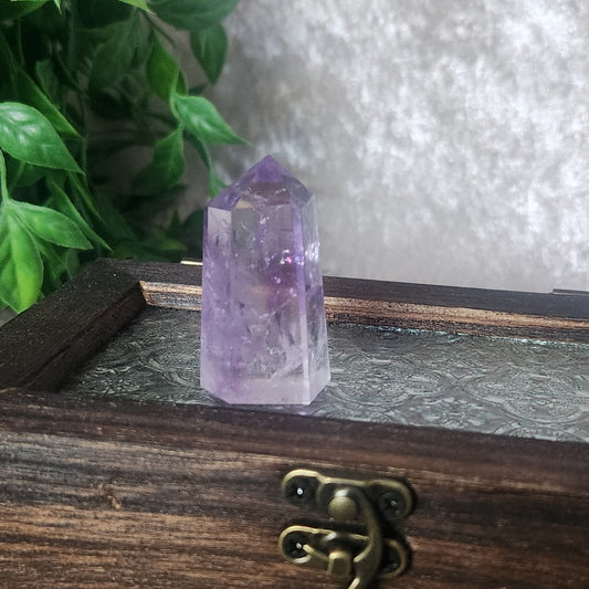Brazilian amethyst mini tower showing deep purple colour, polished point, and natural inclusions