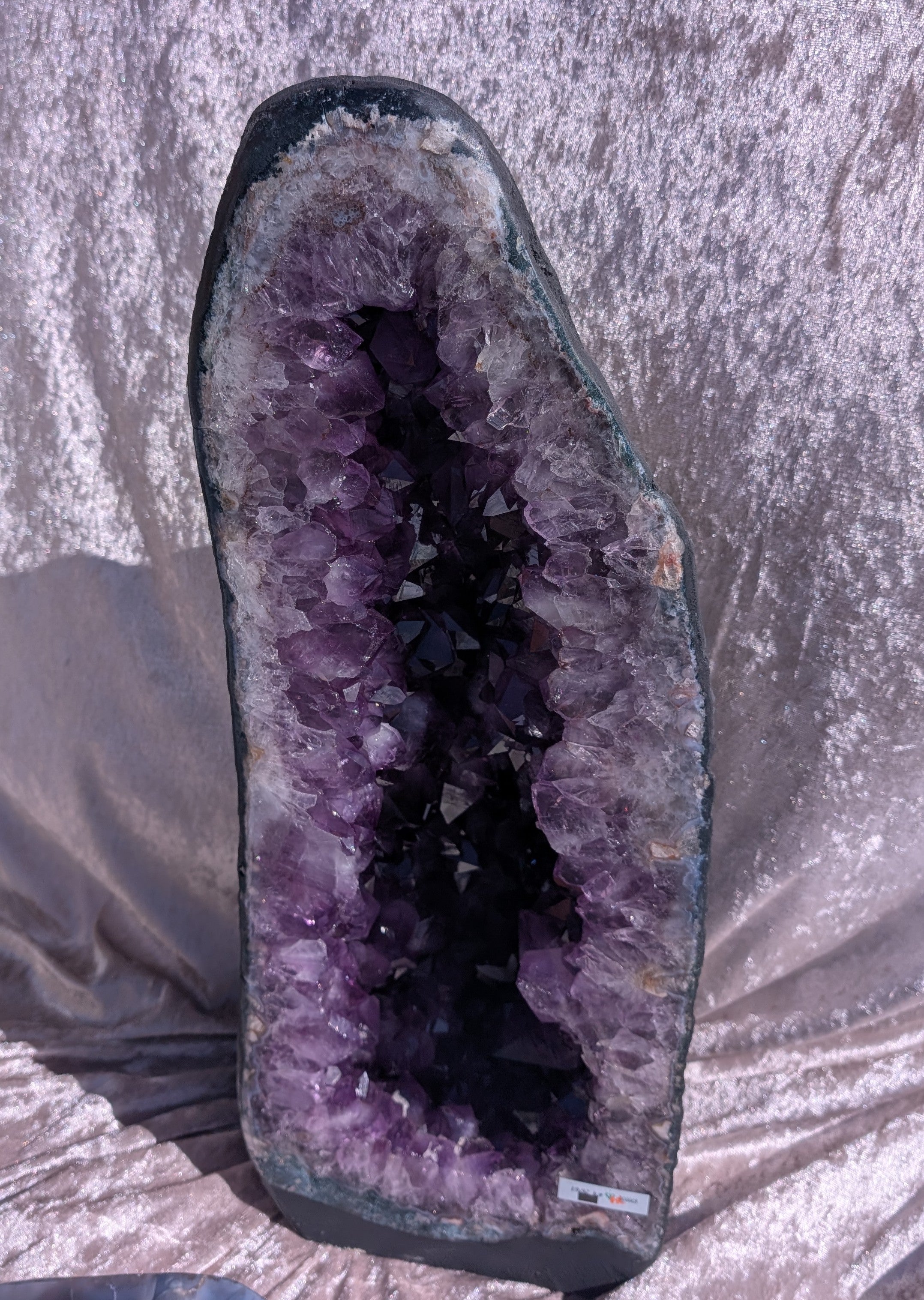 Large Brazilian Amethyst Cathedral in natural light with lavender velvet background