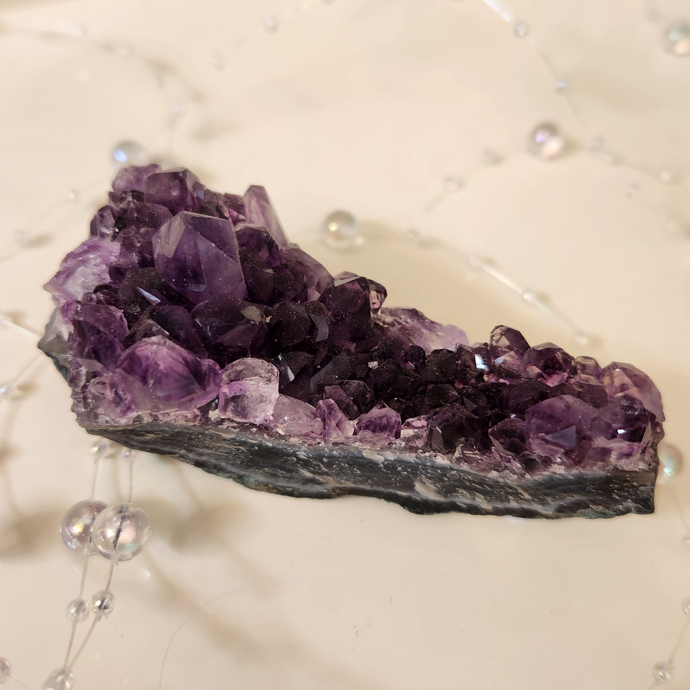 Side view of amethyst cluster highlighting raw crystal structure