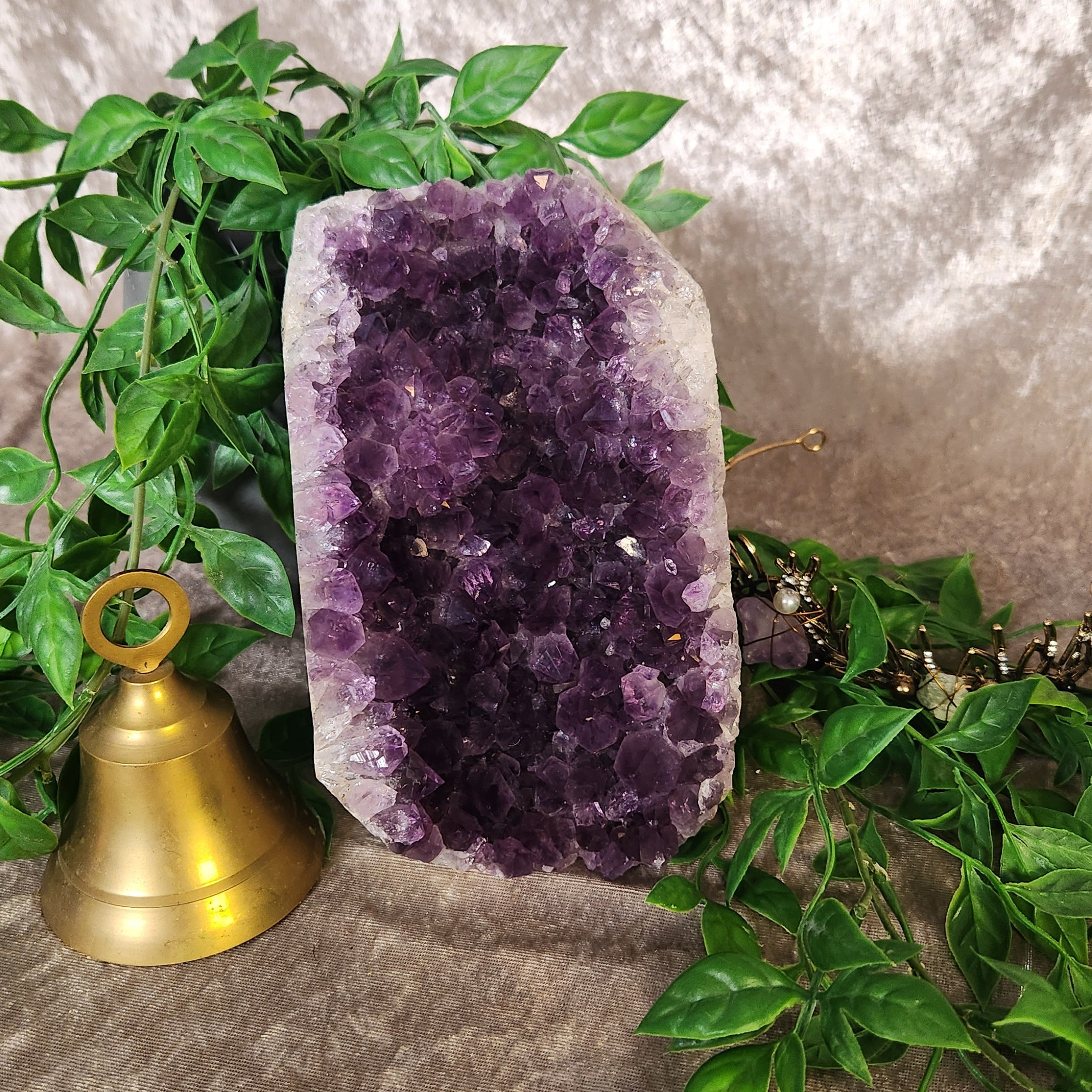 Natural amethyst cluster with sparkling crystal points and cut base