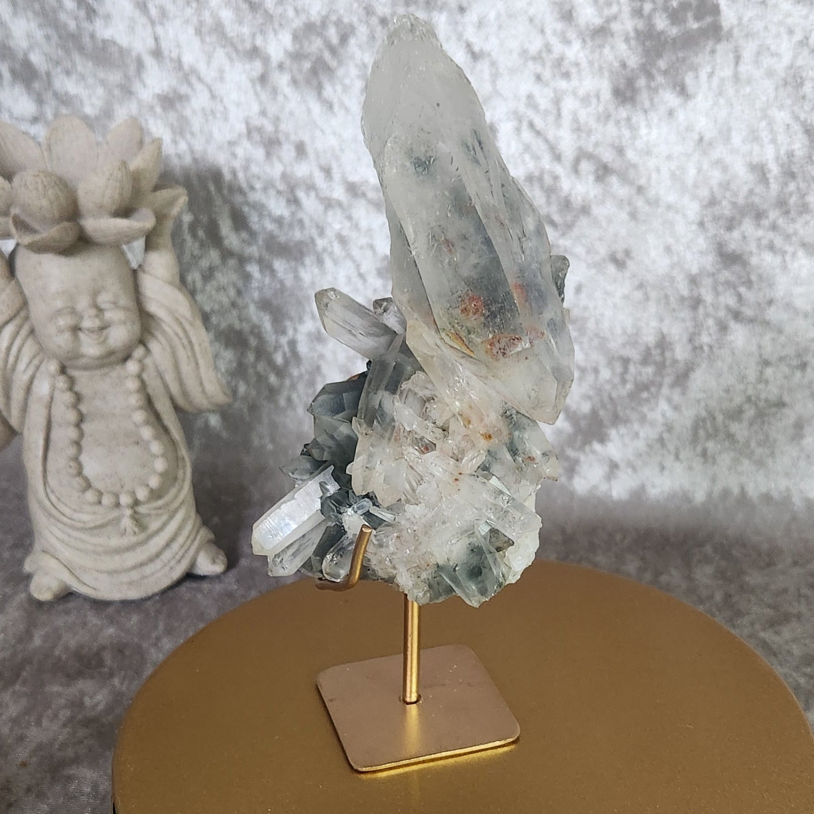 Blue Tara Quartz cluster on gold stand with bluish inclusions
