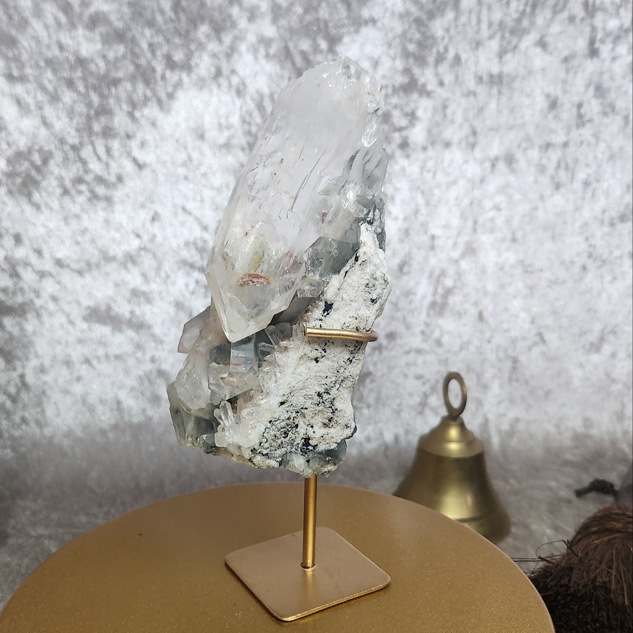 Rear view of Blue Tara Quartz Cluster on gold stand, highlighting raw matrix, natural texture, and grounding mineral base.