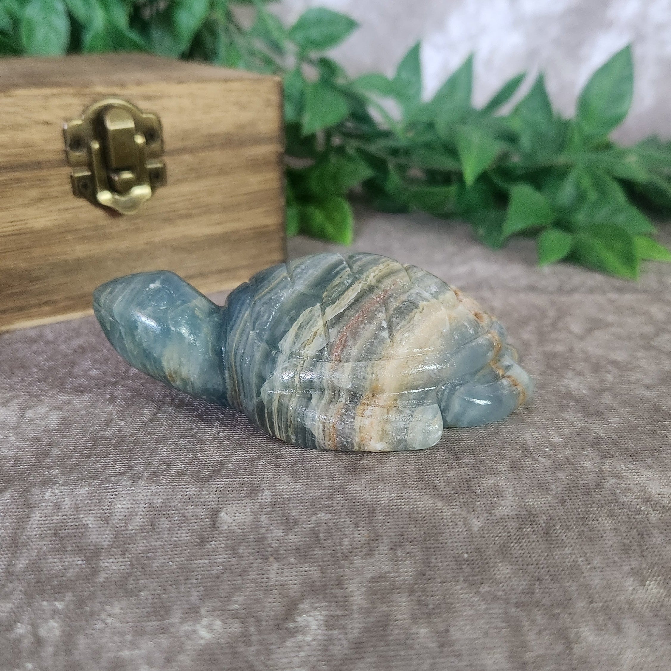 Blue onyx turtle figurine showcasing natural banded patterns