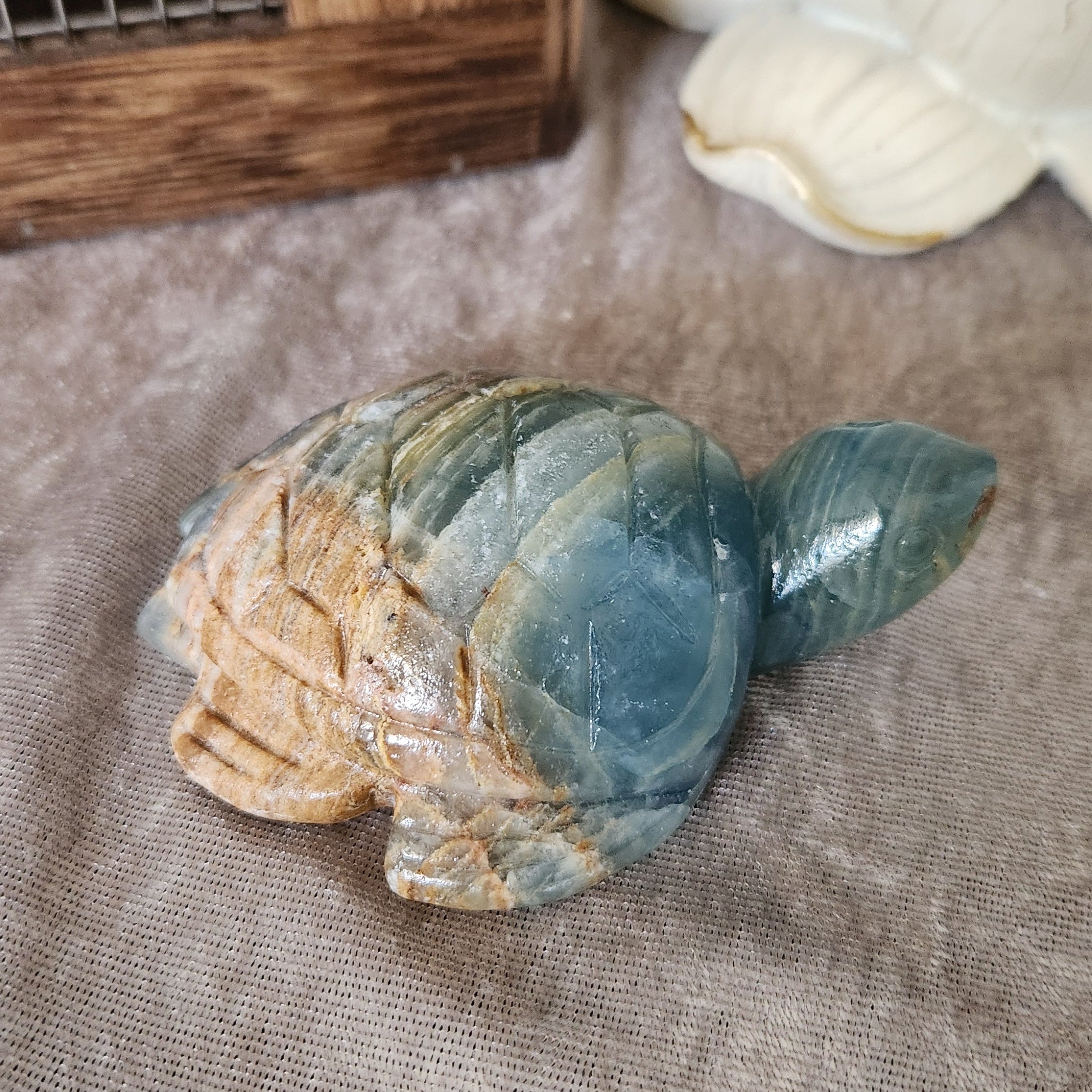Blue onyx turtle crystal carving with natural banded pattern
