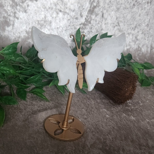 Decorative quartz butterfly with translucent crystal wings on circular gold base