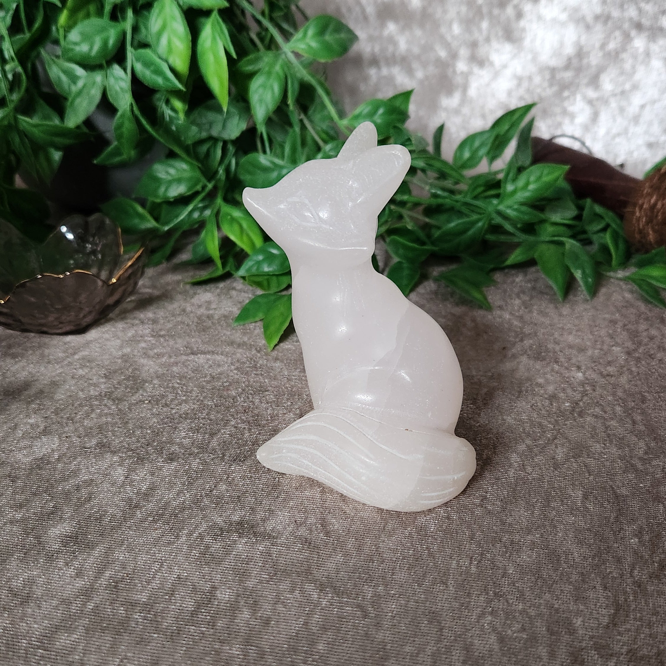 Calcite fox crystal carving photographed from side angle highlighting smooth polish