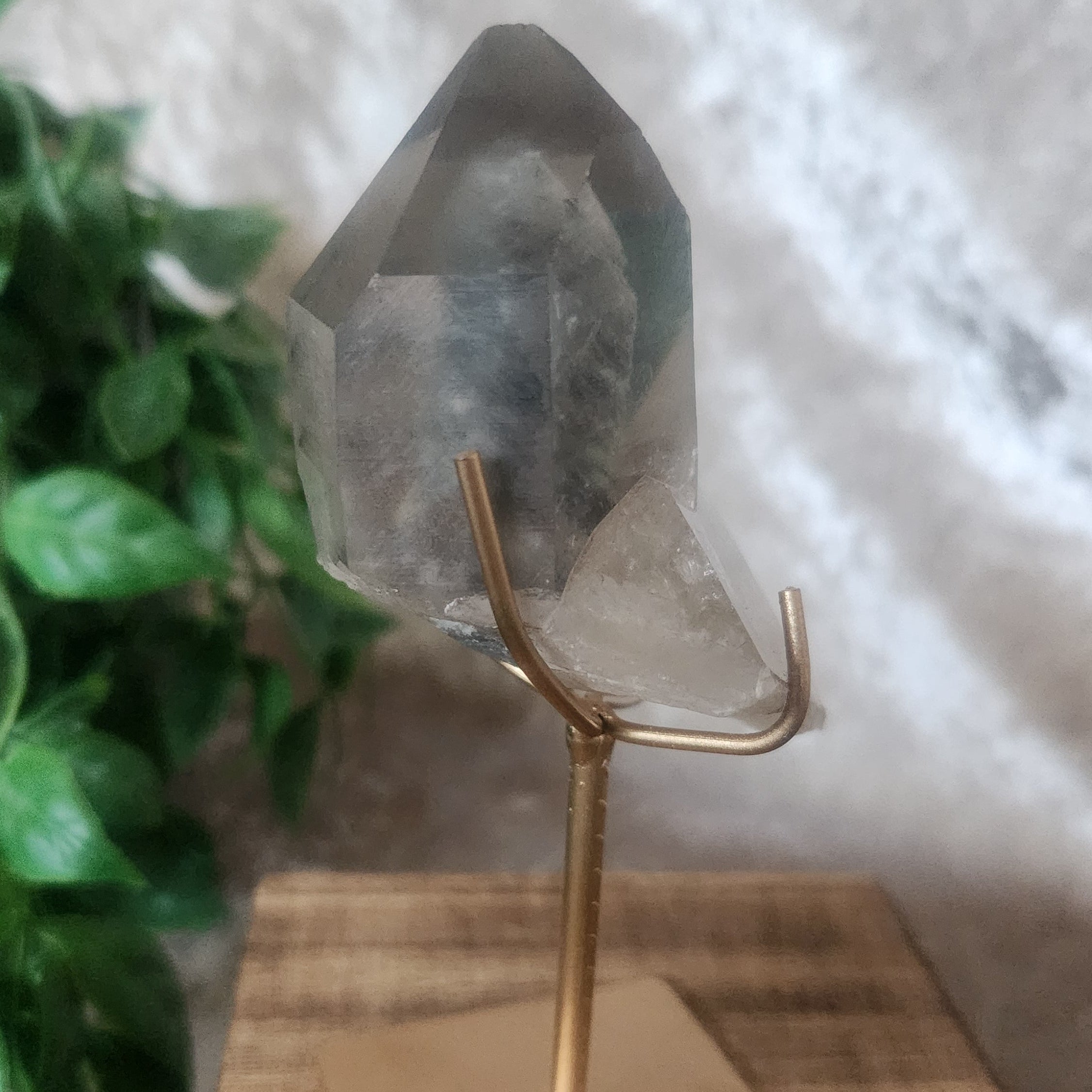Blue Tara Quartz specimen on metal stand with wood base