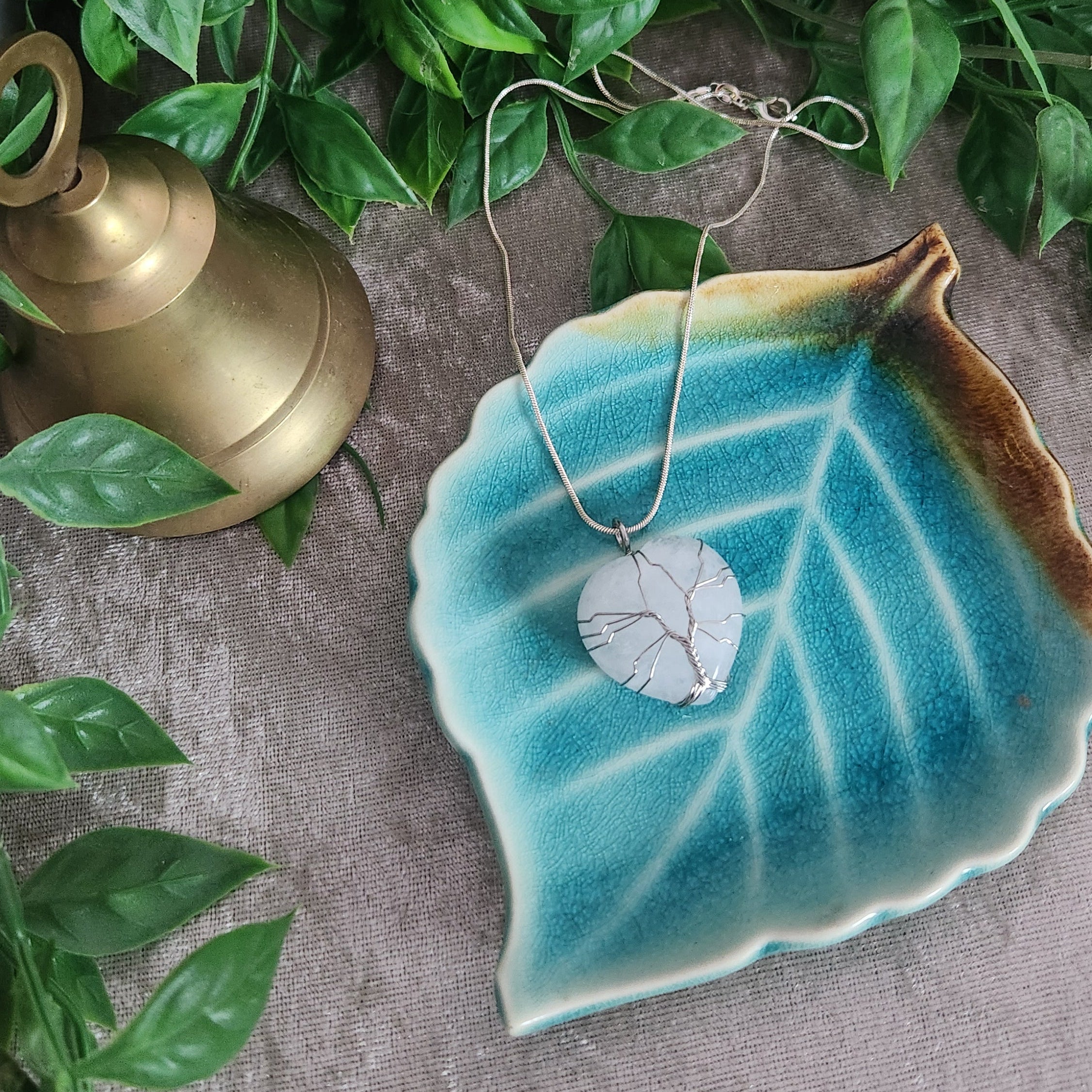 Hand wrapped clear quartz heart pendant photographed for crystal jewellery