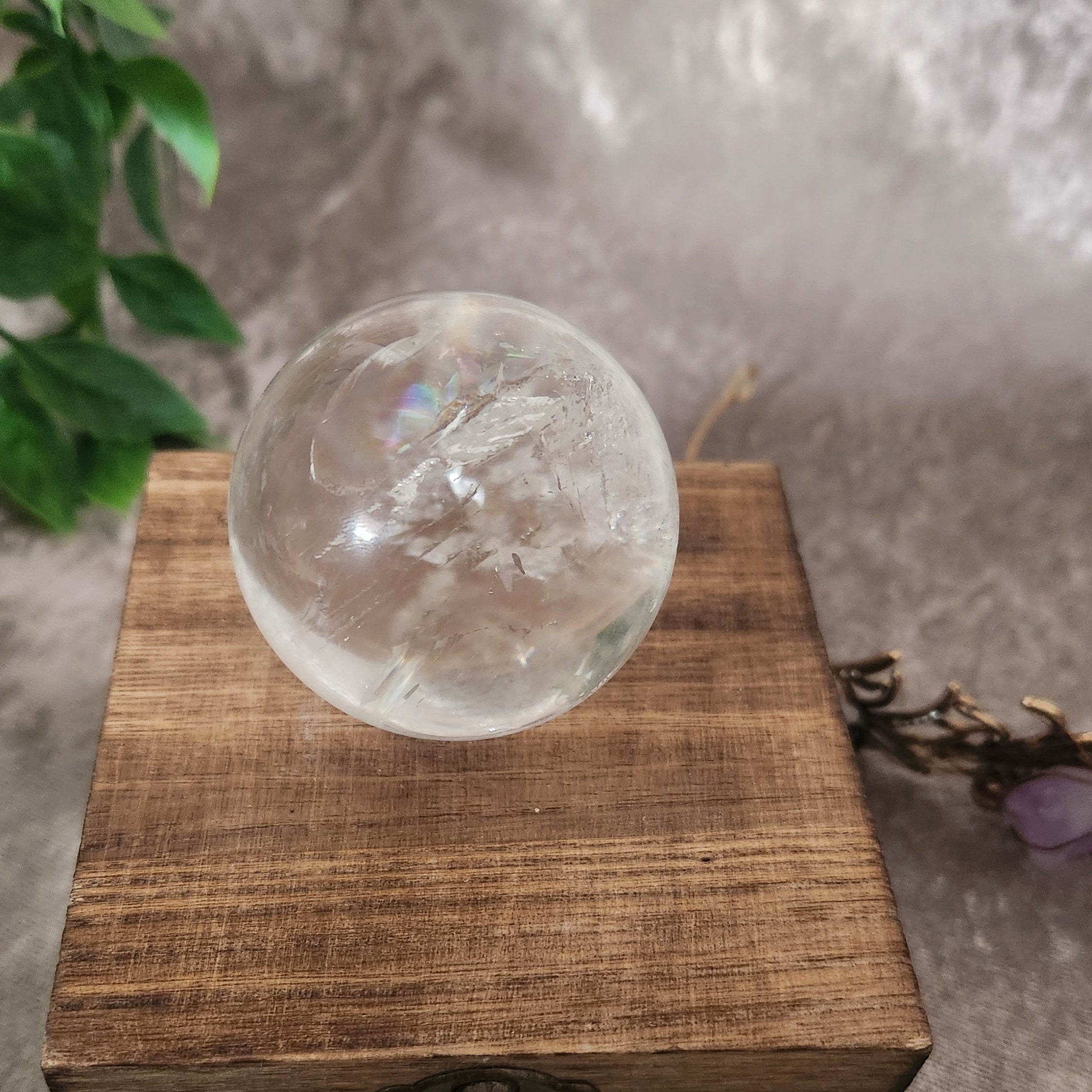 Polished clear quartz sphere highlighting pure crystal structure