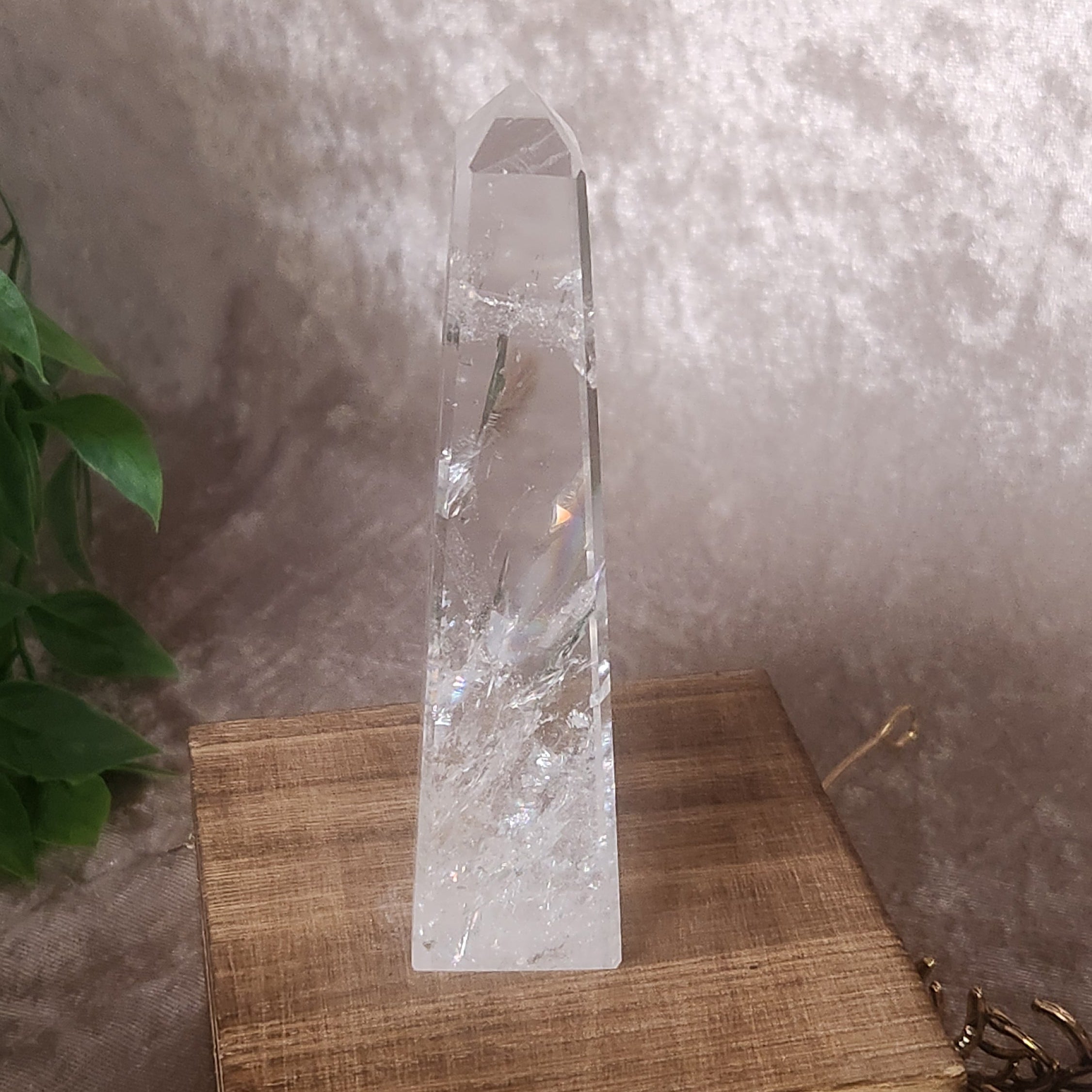 Four sided clear quartz tower with polished finish and internal detail
