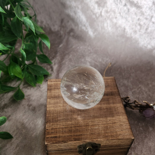 Clear quartz crystal sphere with natural transparency and light refraction