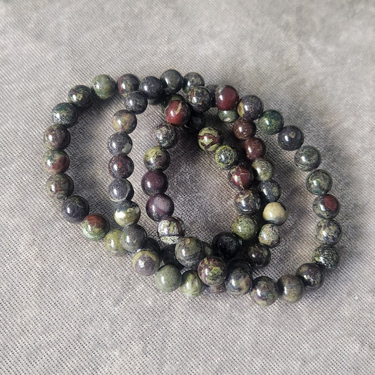 Natural Dragon’s Blood Jasper crystal bracelet displayed on a neutral background