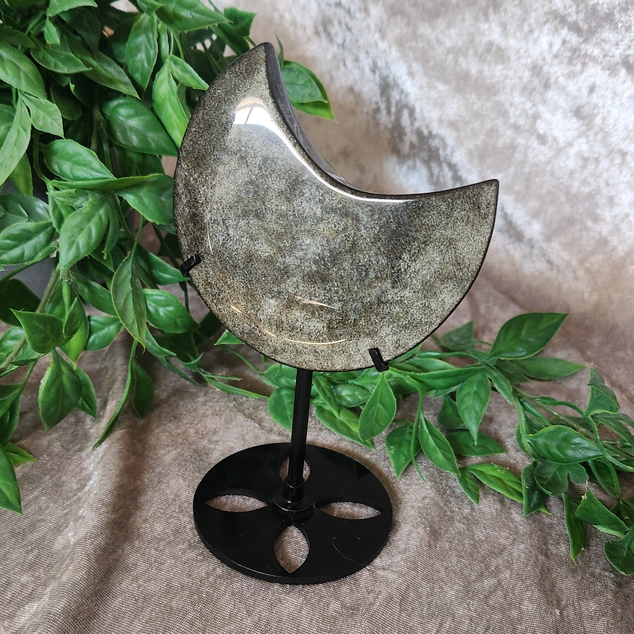 Golden Obsidian Moon on stand with golden velvet background and greenery