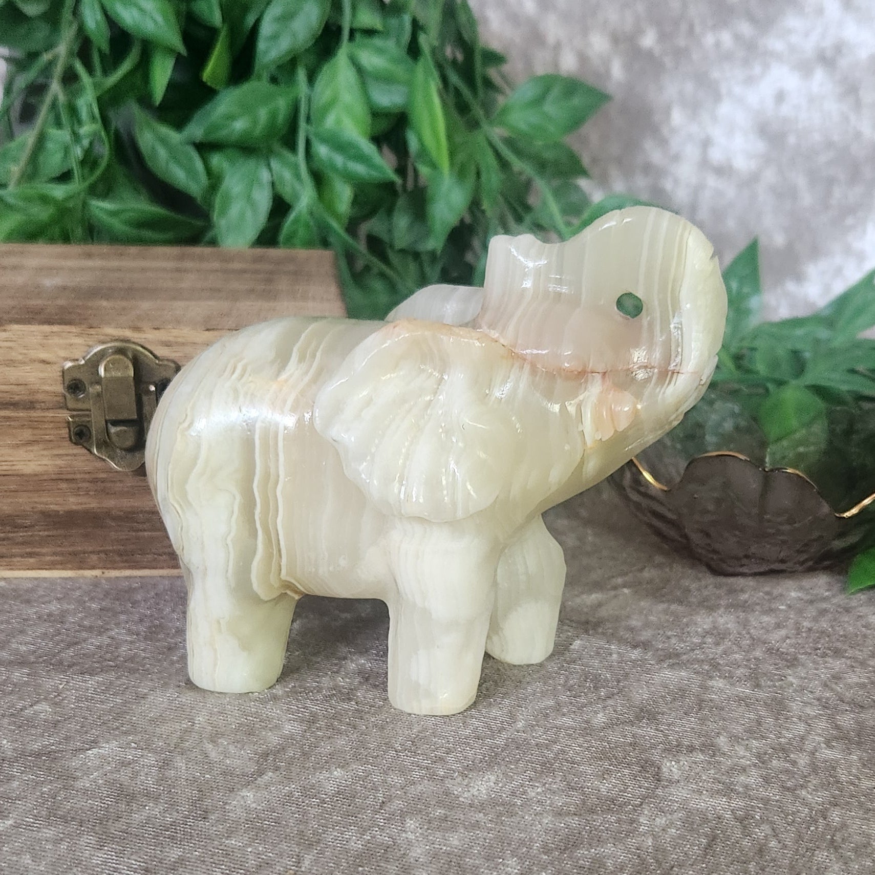 Green Onyx elephant carving with soft green and cream banding