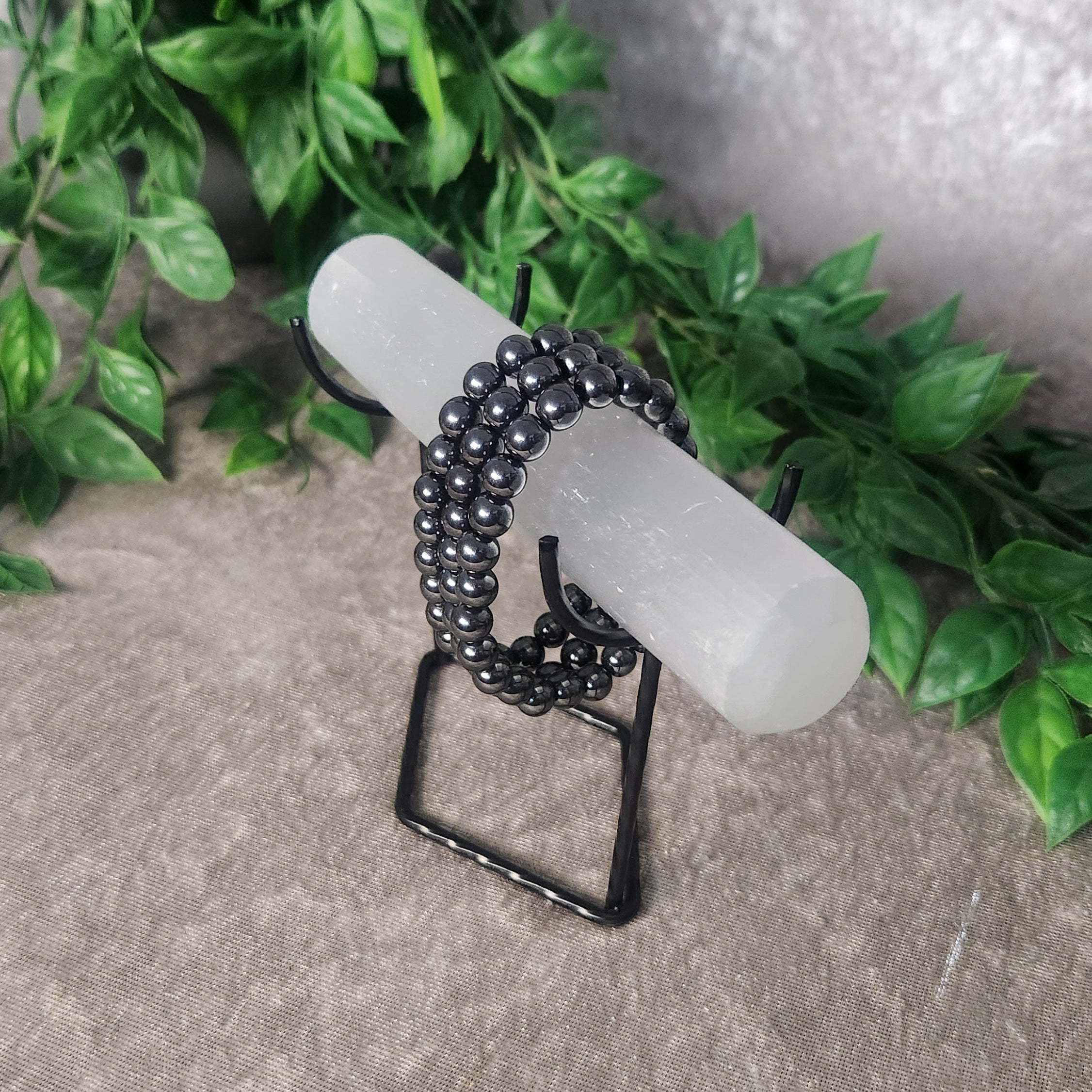 Grounding Hematite crystal bracelet styled on a display stand