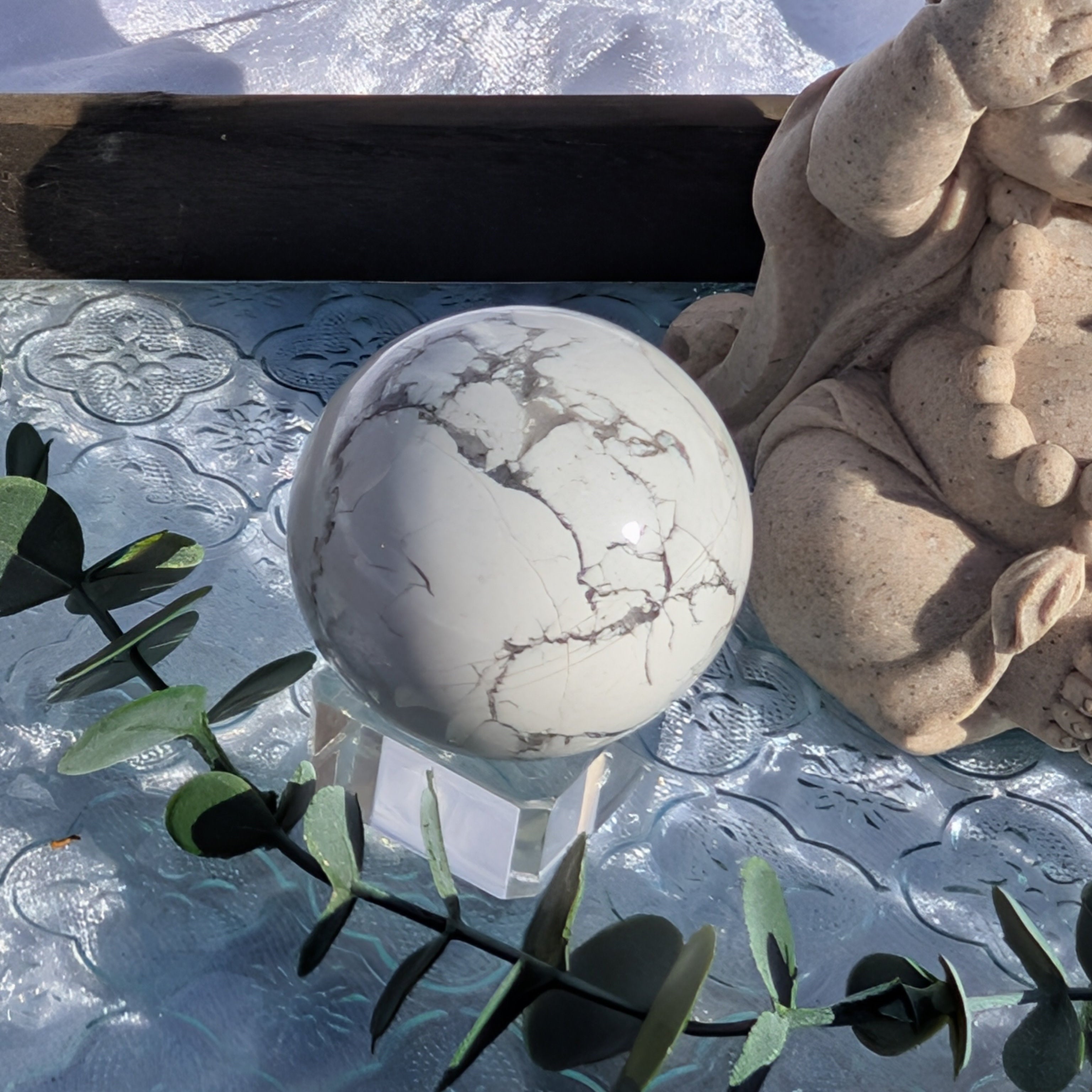 White Howlite Sphere on vintage tray with light greenery and monk statue