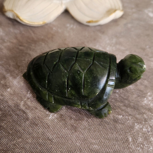 ade turtle crystal carving with polished green stone surface