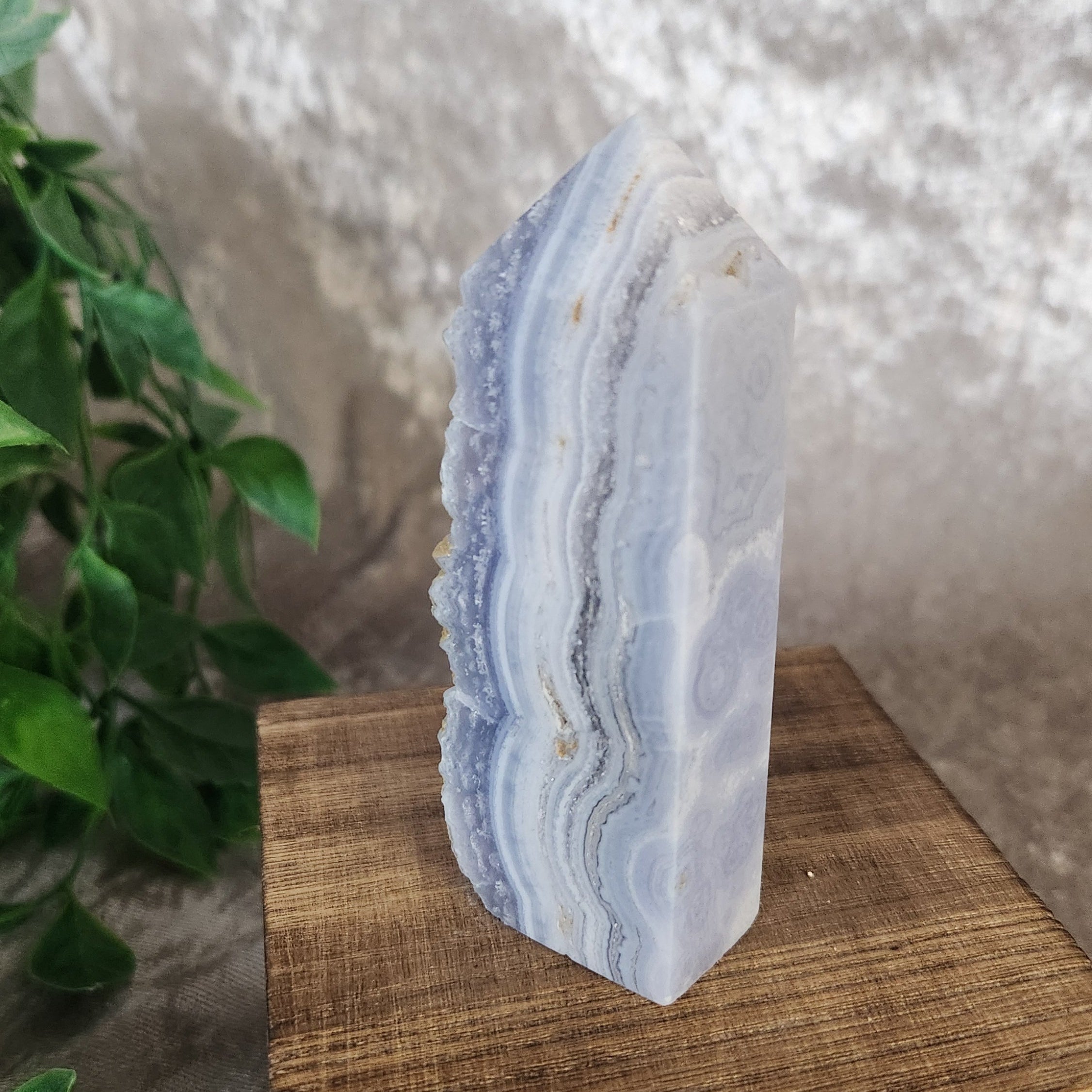 Polished blue lace agate crystal tower with pale blue layered patterns and visible druzy detail