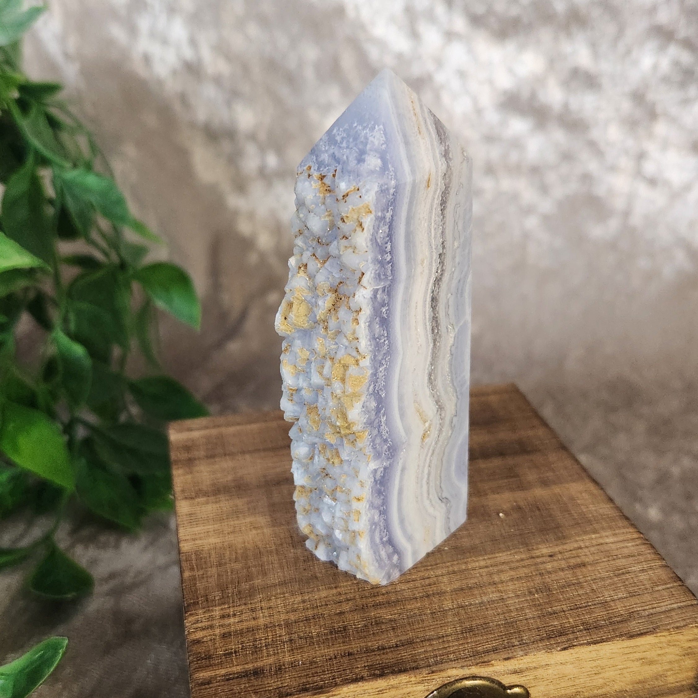 Blue lace agate tower crystal showing delicate banding and textured druzy quartz formation