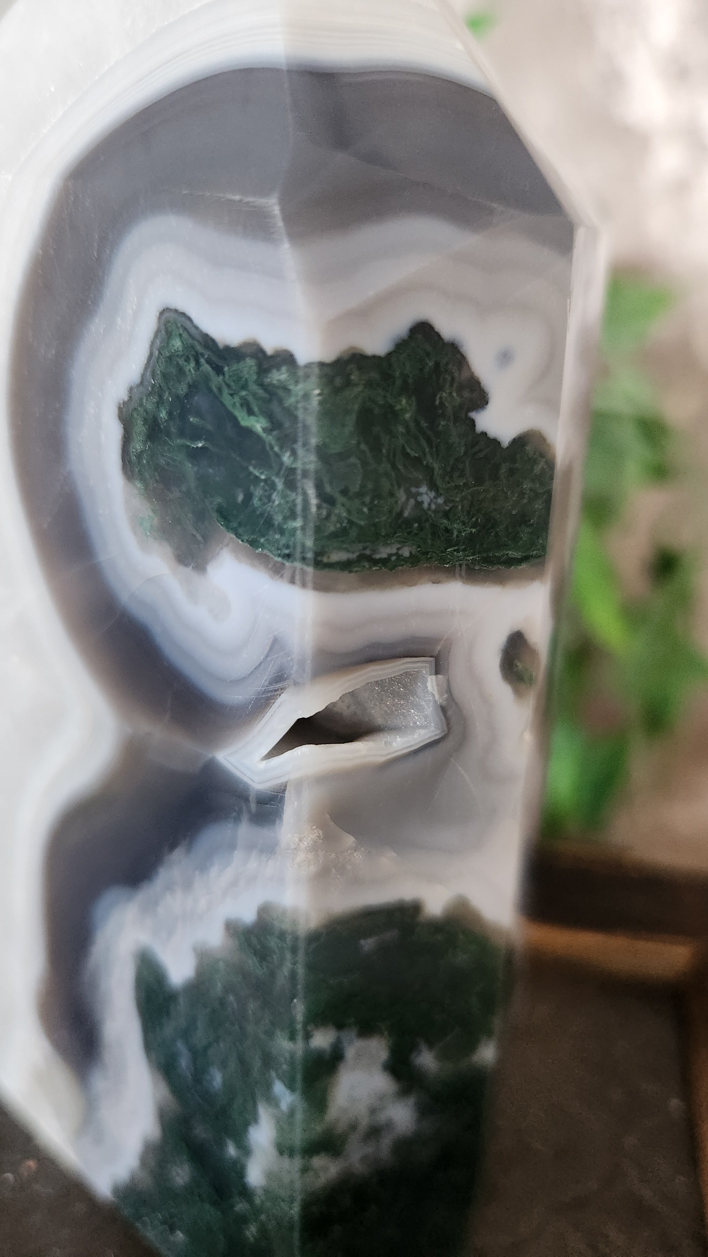 Large parallax moss agate crystal tower showing translucent agate layers and natural moss formations