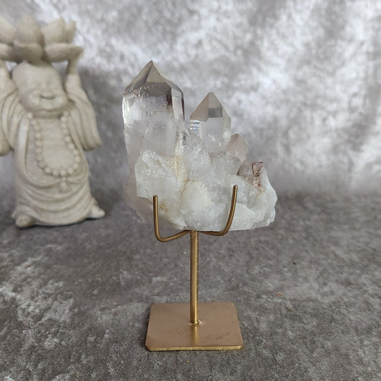 Clear Lemurian quartz cluster with lodolite inclusions on gold stand – 325g