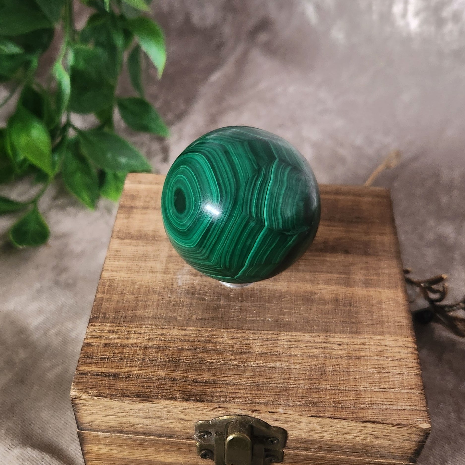 Natural malachite crystal sphere showing concentric green patterns