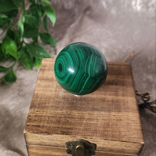 Natural malachite crystal sphere showing concentric green patterns
