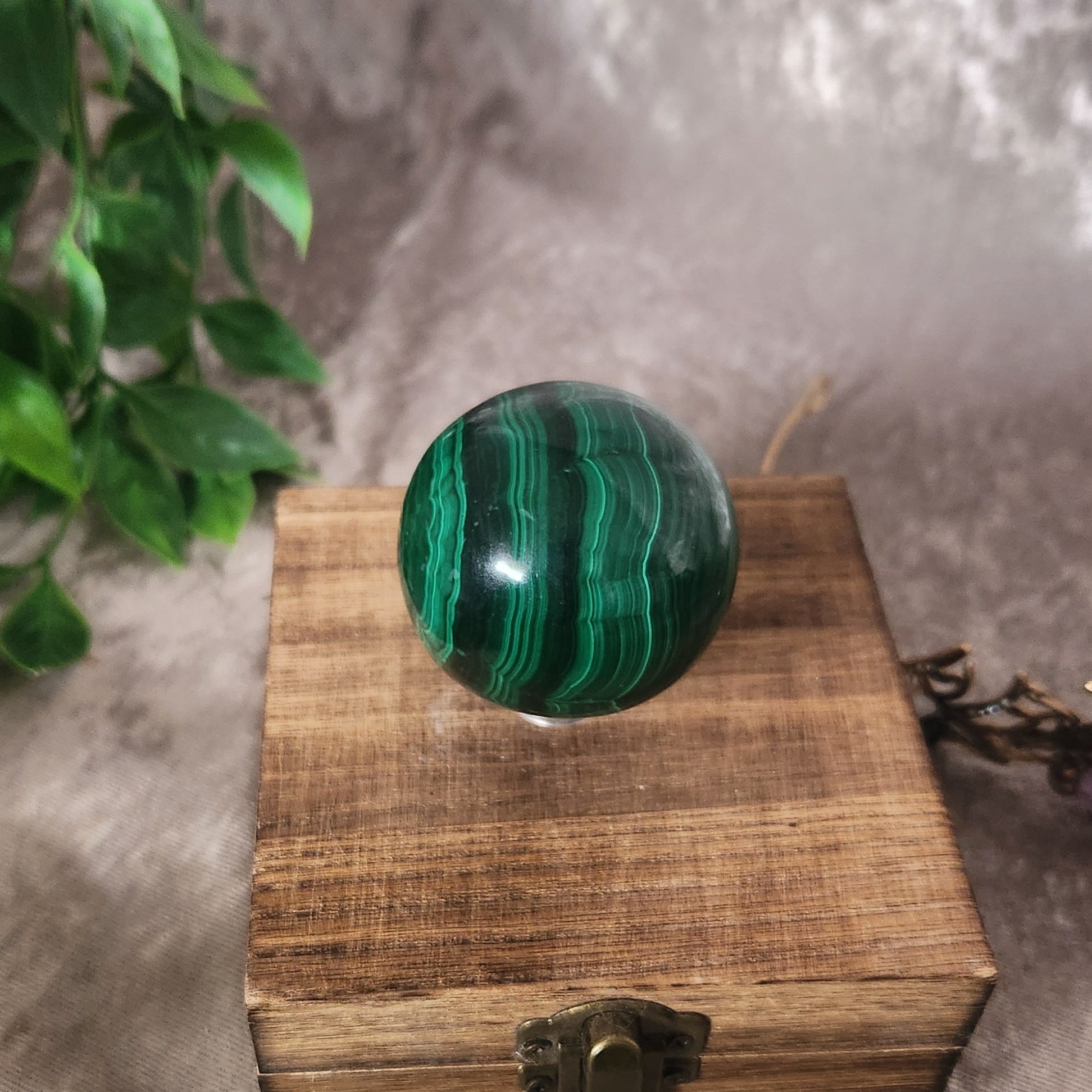 Close-up of polished malachite sphere highlighting natural banding