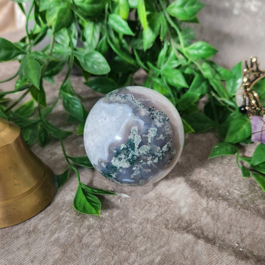 Polished Moss Agate crystal sphere showing organic moss-like patterns