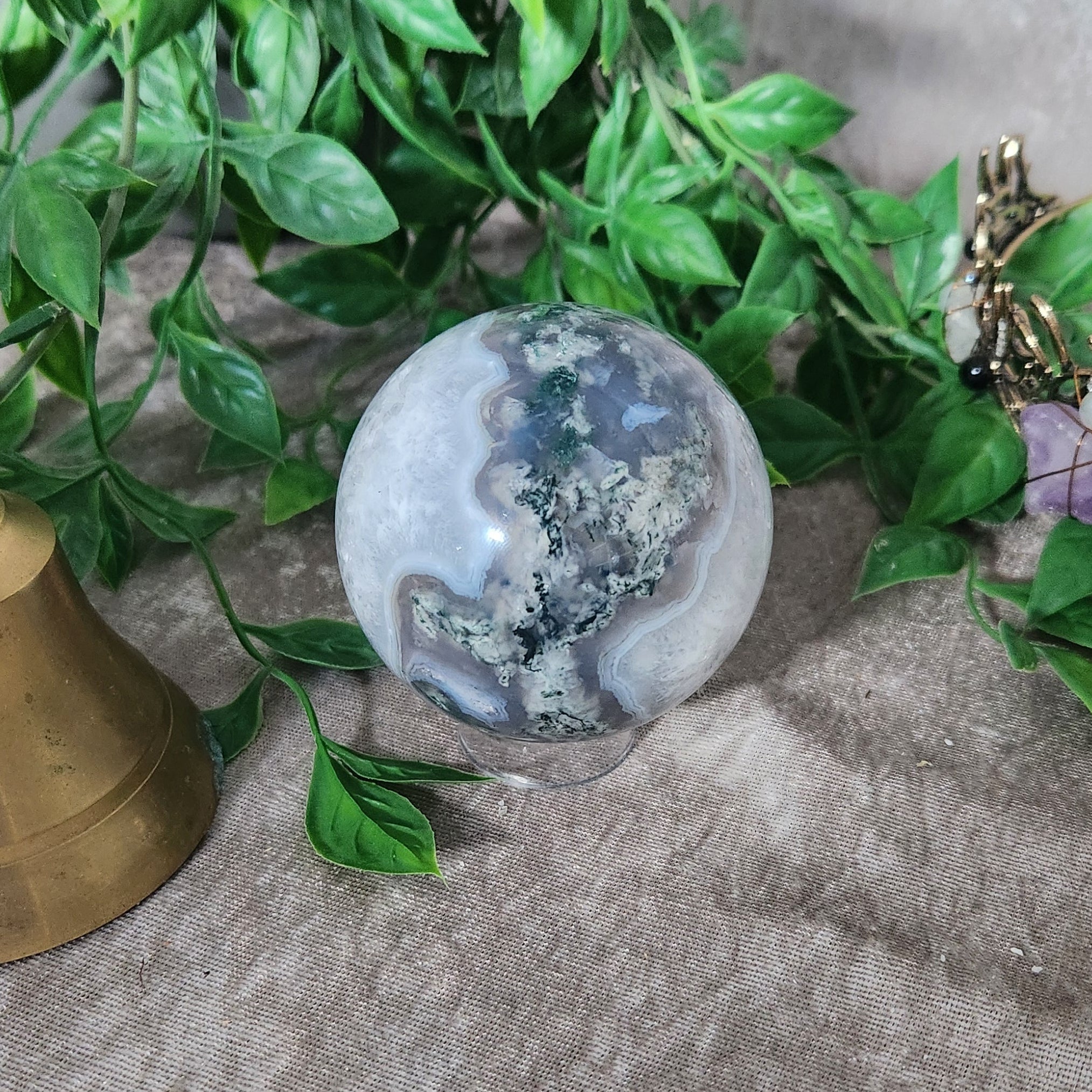 Natural Moss Agate sphere photographed in soft neutral light