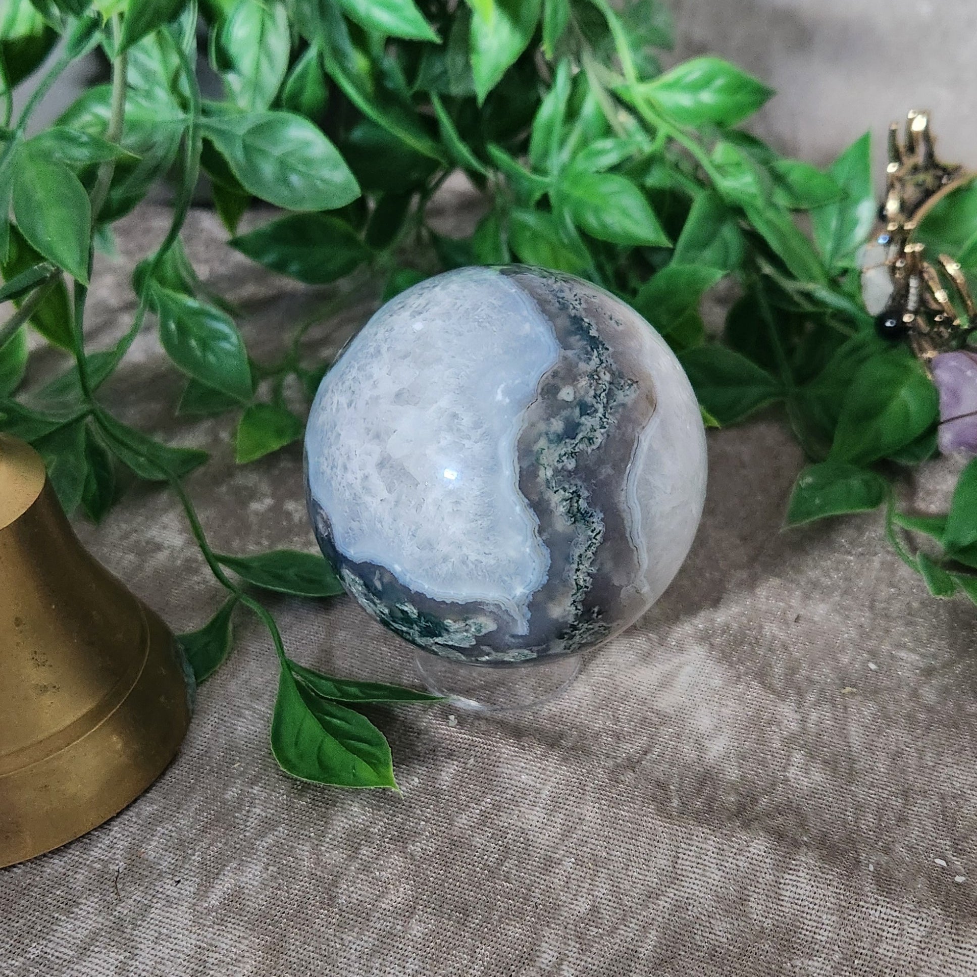 Close-up of Moss Agate sphere highlighting natural internal formations