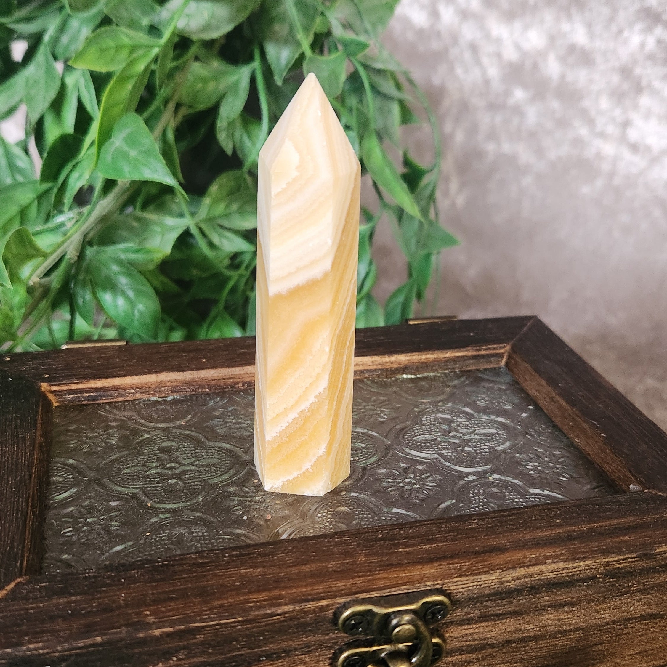 Orange banded calcite tower crystal with smooth polished finish and soft layered pattern