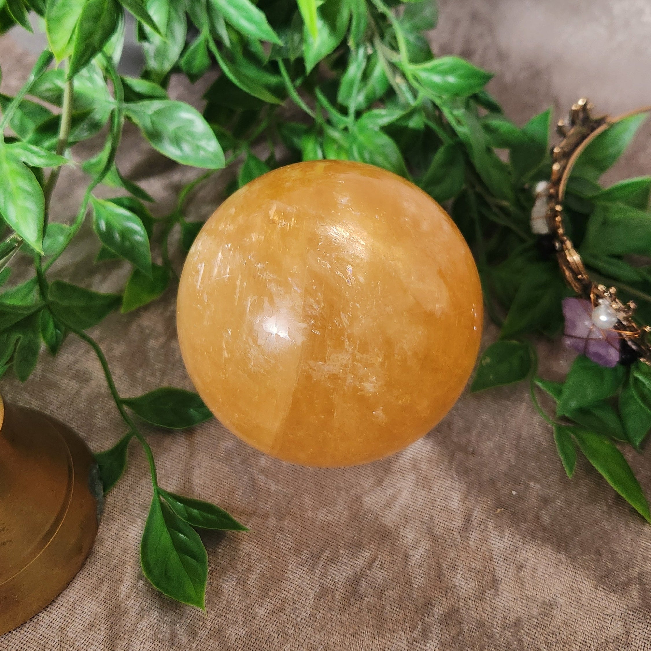 Honey Calcite crystal sphere displaying natural amber hues