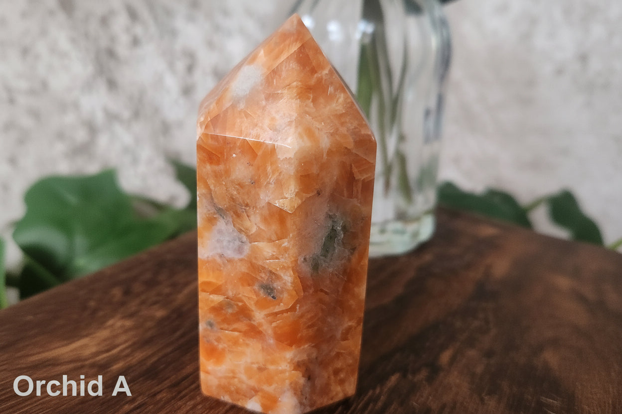 Polished orchid calcite six sided generator featuring grounding tourmaline inclusions