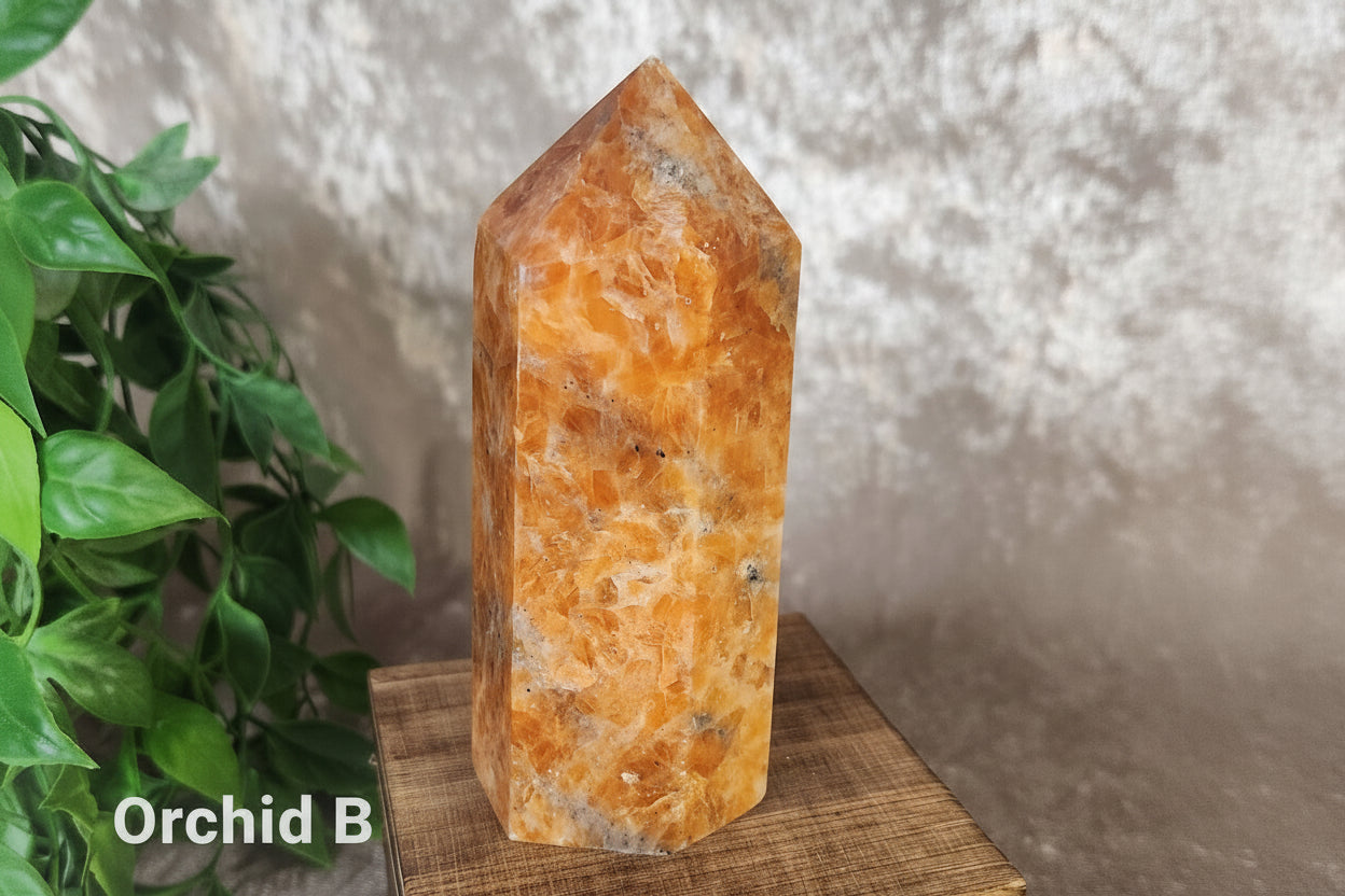 Peach and blush orchid calcite crystal generator with black tourmaline veining