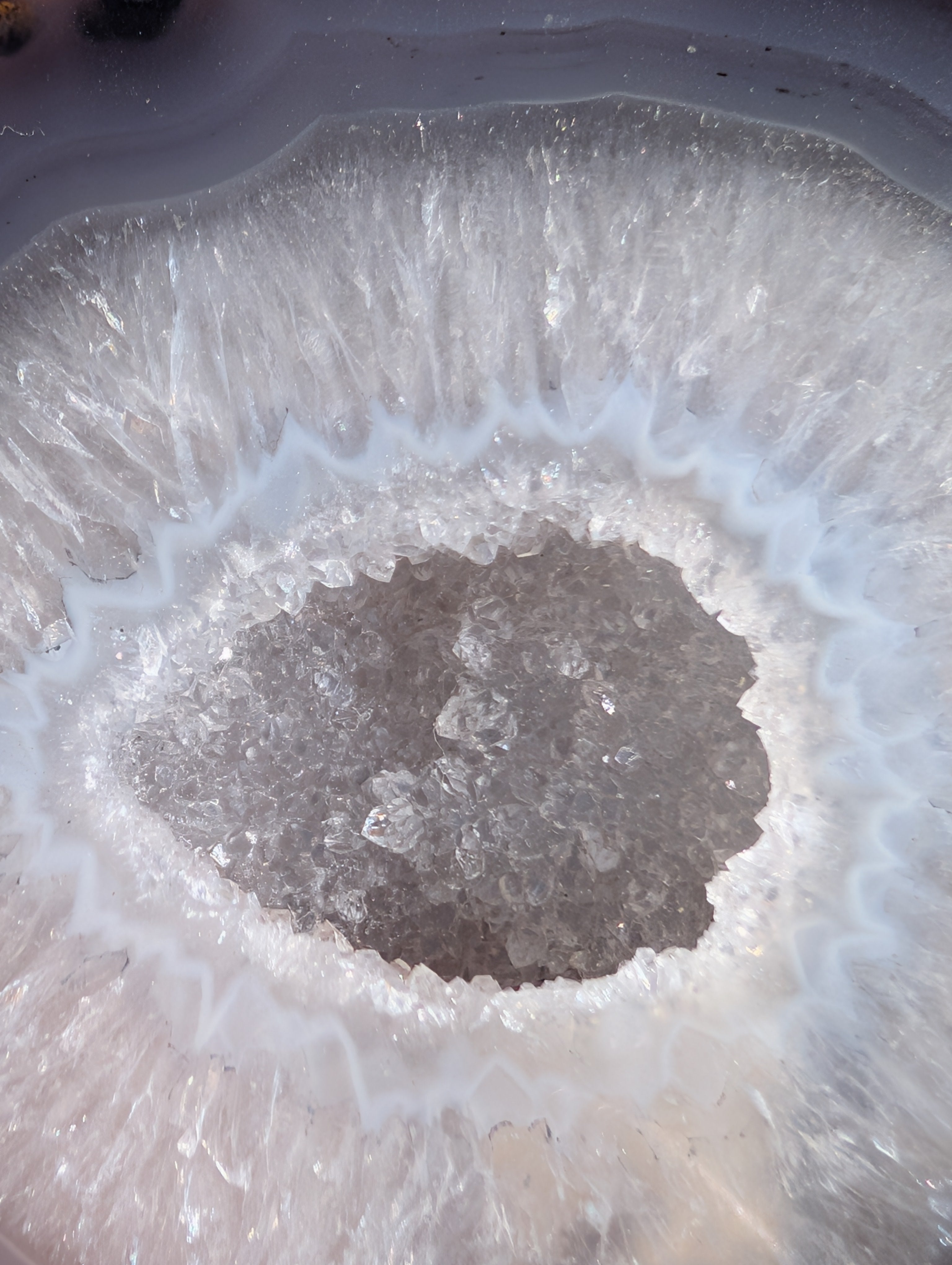 front view close up of agate geode with stunning banding and druzy