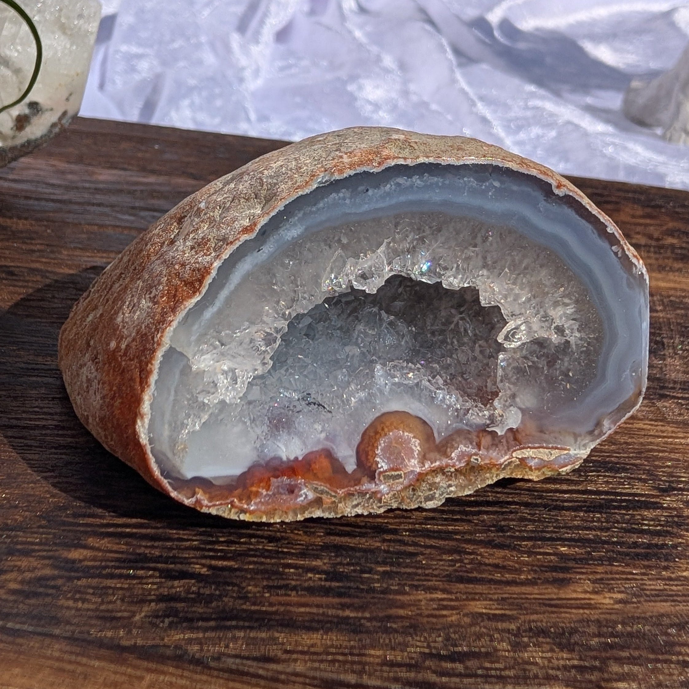 Natural Agate with blue banding surrounding quartz geode displayed outdoors