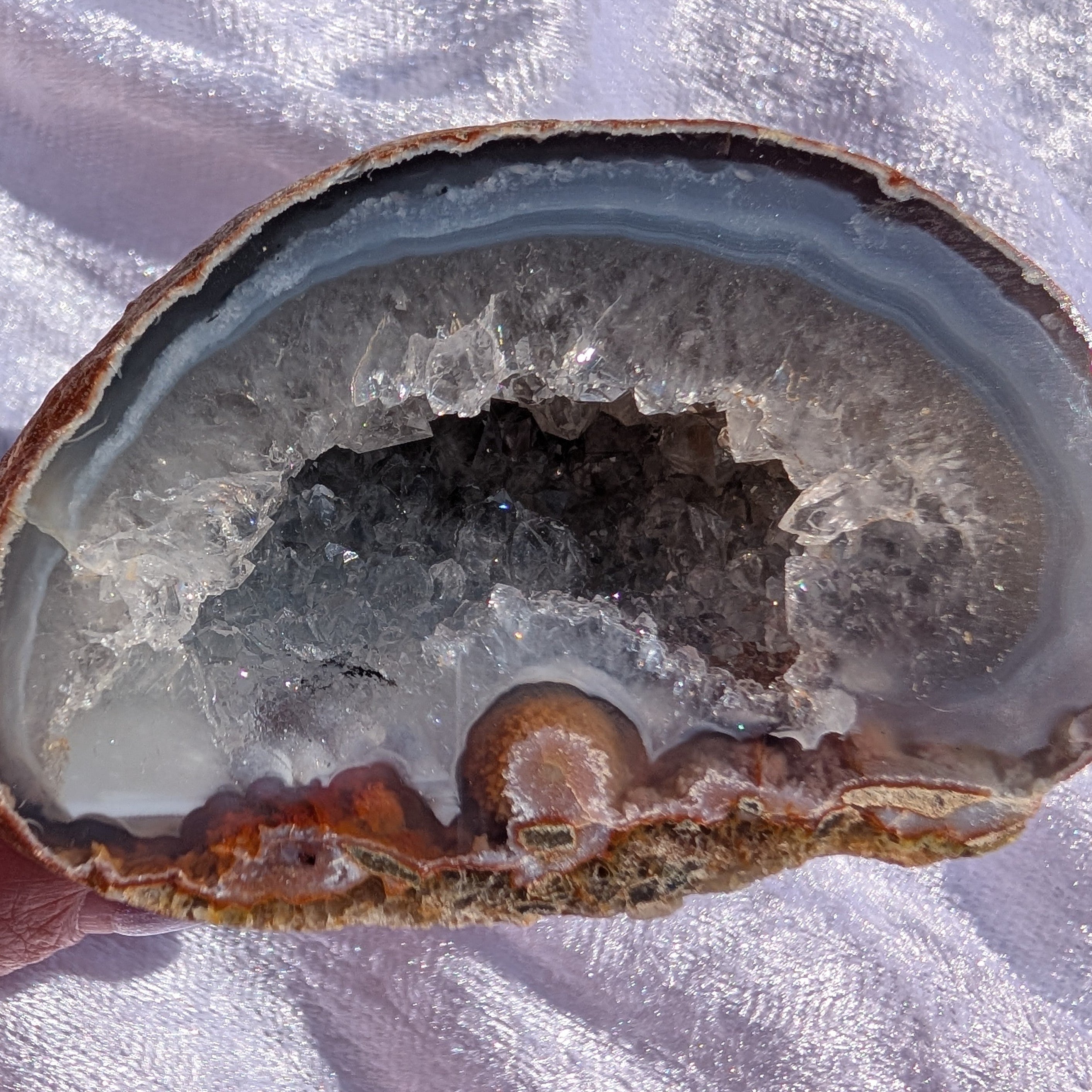 Close up of agate geode with quartz druzy and unusual banding