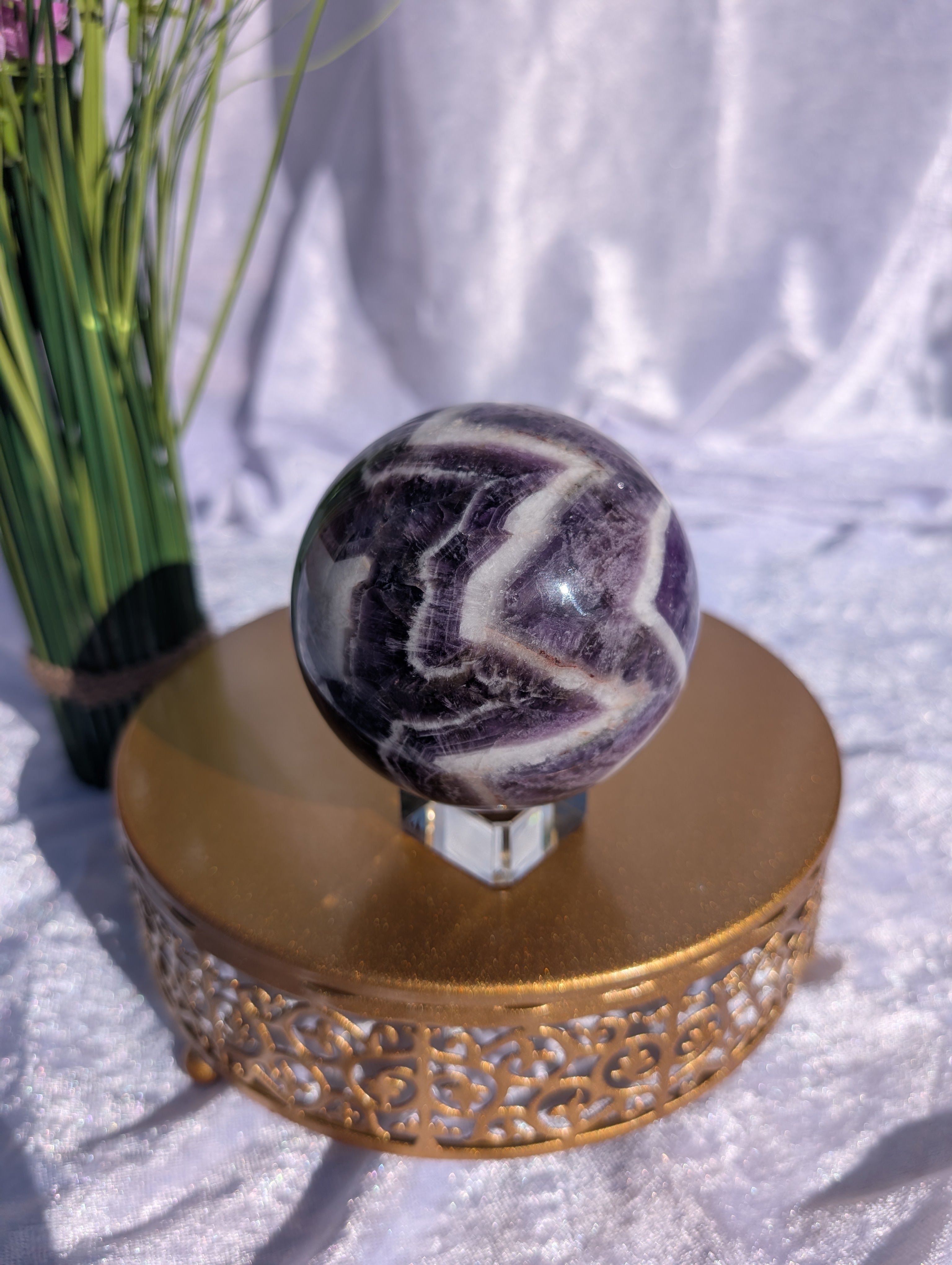 Large Chevron Amethyst Sphere makes a striking boho luxe style display on golden stand
